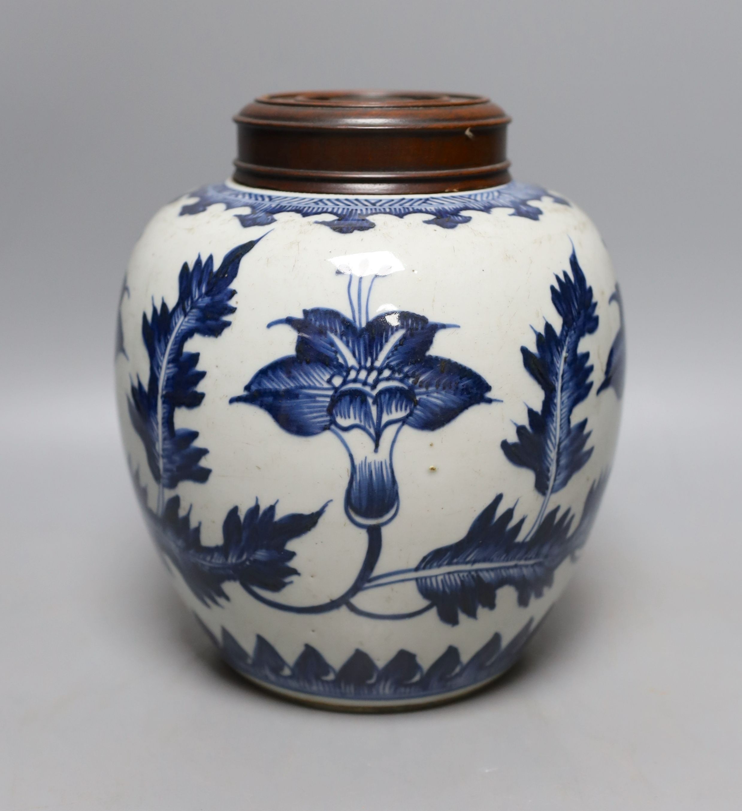 A 18th/19th century Chinese blue and white jar and wood cover - 22cm high